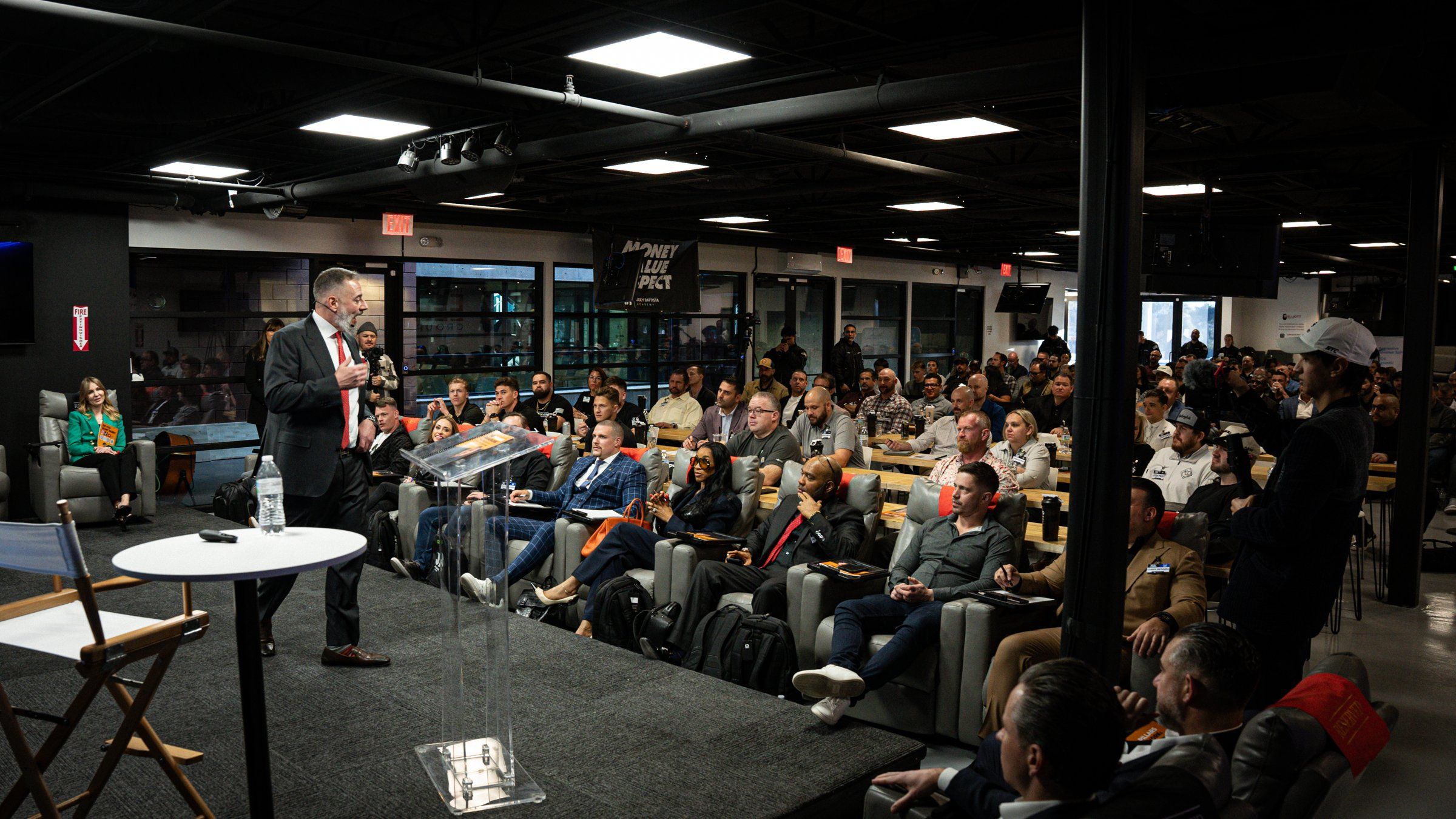 Joey Battista speaking to a full room